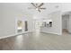 Open-concept living area featuring wood floors, with an adjacent modern kitchen and dining area at 11345 Thrasher Ave, Weeki Wachee, FL 34614