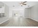 Bright open-concept living room featuring tile floors, a ceiling fan, and entry door at 11345 Thrasher Ave, Weeki Wachee, FL 34614