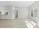 A bright living room featuring neutral paint, a modern chandelier, tile flooring, and a large window at 11345 Thrasher Ave, Weeki Wachee, FL 34614