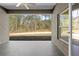 Back patio featuring tile flooring and a view of the natural forest at 11345 Thrasher Ave, Weeki Wachee, FL 34614