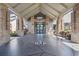 Elegant entryway features brick pillars, a covered portico, and decorative concrete flooring at 11428 Alden Ct, Hudson, FL 34667