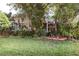 Lush front yard featuring beautiful plants and well-kept lawn at 12202 Bear Trap Ln, Hudson, FL 34667