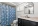 Bathroom featuring a vanity with marble countertops and a shower with decorative floral shower curtain at 12214 Silk Oak Ln, Hudson, FL 34667