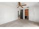 This bedroom features a ceiling fan, closet, and neutral carpet at 12214 Silk Oak Ln, Hudson, FL 34667