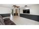 Spacious living room with tile flooring, a ceiling fan, and a TV at 12214 Silk Oak Ln, Hudson, FL 34667