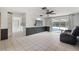 Inviting living room with tile flooring, ceiling fan, and sliding glass doors leading to the pool at 12214 Silk Oak Ln, Hudson, FL 34667