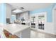 Kitchen featuring a breakfast bar overlooking backyard views through glass doors at 12215 Skyler Ln, Spring Hill, FL 34609