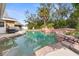 Inviting backyard pool with unique rock features and well-maintained landscaping, ideal for summer fun at 12215 Skyler Ln, Spring Hill, FL 34609