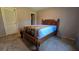 Bedroom featuring a wooden bed frame and carpeted flooring at 12406 Eagleswood Dr # B, Hudson, FL 34667