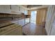 Functional kitchen with tile flooring, white cabinetry, and a sliding door to the outdoors at 12406 Eagleswood Dr # B, Hudson, FL 34667
