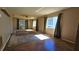 Spacious living room featuring hardwood floors, bright windows, and a ceiling fan at 12406 Eagleswood Dr # B, Hudson, FL 34667