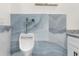 Bathroom showcasing a modern urinal, white vanity with granite countertop, and blue accent wall at 12706 N Ola Ave, Tampa, FL 33612
