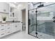 Modern bathroom with a glass-enclosed shower, white vanity, black fixtures, and stylish tile work at 12706 N Ola Ave, Tampa, FL 33612
