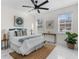 Bright bedroom with large windows, a ceiling fan, white and blue bedding, and modern décor at 12706 N Ola Ave, Tampa, FL 33612