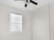 Bright bedroom features a ceiling fan and a window for natural light at 12706 N Ola Ave, Tampa, FL 33612