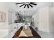 Dining area with a large table and a clear view to the modern kitchen at 12706 N Ola Ave, Tampa, FL 33612