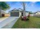 Charming single-Gathering home boasts a well-manicured lawn and a two-car garage at 12706 N Ola Ave, Tampa, FL 33612