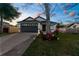 Charming single Gathering home featuring well-maintained lawn and a two car garage with a long driveway at 12706 N Ola Ave, Tampa, FL 33612