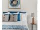 Bedroom close-up featuring white bedding, decorative pillows, and a bedside table with lamp at 12706 N Ola Ave, Tampa, FL 33612