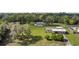 Aerial view of a single-story home with a large front yard surrounded by mature trees at 12757 Circle Lake Dr, Hudson, FL 34669