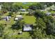Overhead view of a home with a large backyard and a pond surrounded by mature trees at 12757 Circle Lake Dr, Hudson, FL 34669