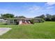 Spacious backyard with a charming patio and lush green lawn, perfect for outdoor relaxation and entertaining at 12757 Circle Lake Dr, Hudson, FL 34669