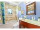 The bathroom features a jacuzzi tub, shower, toilet, sink, and glass countertop at 12757 Circle Lake Dr, Hudson, FL 34669