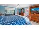 This primary bedroom features a large bed, dresser with a mirror and closet at 12757 Circle Lake Dr, Hudson, FL 34669