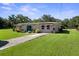 Charming single-story home featuring a well-manicured lawn and inviting curb appeal at 12757 Circle Lake Dr, Hudson, FL 34669