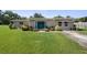 Charming single-story home with a well-manicured front lawn and inviting double door entry at 12757 Circle Lake Dr, Hudson, FL 34669