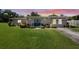 Charming single-story home with a well-manicured front lawn and inviting double door entry at 12757 Circle Lake Dr, Hudson, FL 34669