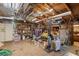 Spacious cluttered garage with wood ceiling beams, shelving, storage, and concrete floor at 12757 Circle Lake Dr, Hudson, FL 34669
