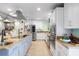 Gourmet kitchen featuring stainless steel appliances, custom cabinetry, and a spacious island at 12757 Circle Lake Dr, Hudson, FL 34669