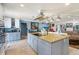 Kitchen with large center island, cooktop, modern pendant lighting and adjacent breakfast area at 12757 Circle Lake Dr, Hudson, FL 34669