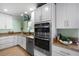 Modern kitchen sink with granite countertops and a window overlooking the landscaped backyard at 12757 Circle Lake Dr, Hudson, FL 34669