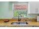 Kitchen sink with granite countertops and a window overlooking the backyard at 12757 Circle Lake Dr, Hudson, FL 34669
