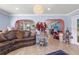 Spacious living room with hardwood floors, arched doorways, and elegant decor at 12757 Circle Lake Dr, Hudson, FL 34669