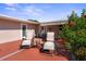 Inviting outdoor patio with comfortable lounge chairs, lush flowers, and privacy from the nearby house at 12757 Circle Lake Dr, Hudson, FL 34669