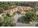 An aerial view of the clubhouse, landscaping, pool, and parking lot at 150 Center Oak Cir, Spring Hill, FL 34609