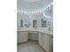 Bathroom featuring double sinks, a vanity area, and a large mirror with vanity lighting at 150 Center Oak Cir, Spring Hill, FL 34609