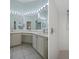 Bright bathroom featuring double sinks, a vanity, and a walk-in shower at 150 Center Oak Cir, Spring Hill, FL 34609