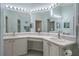 Bright bathroom features a large mirror, double sinks, and vanity area at 150 Center Oak Cir, Spring Hill, FL 34609