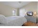 Bedroom with wood floors, a ceiling fan, and a flat screen television on a dresser at 150 Center Oak Cir, Spring Hill, FL 34609