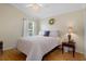 Bedroom with wood floors, a ceiling fan, and a queen bed by a window at 150 Center Oak Cir, Spring Hill, FL 34609