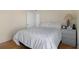 Cozy bedroom featuring a comfortable bed, hardwood floors, and a dresser at 150 Center Oak Cir, Spring Hill, FL 34609