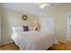 Bedroom with wood floors, a wreath on the wall, and a queen sized bed at 150 Center Oak Cir, Spring Hill, FL 34609
