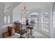 Sun-drenched breakfast nook with large windows and a hanging chandelier at 150 Center Oak Cir, Spring Hill, FL 34609