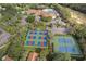 An aerial shows tennis and pickleball courts, and a clubhouse in a scenic community at 150 Center Oak Cir, Spring Hill, FL 34609