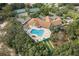 An aerial view highlights the pool, bocce ball, and tennis/pickleball courts in a vibrant, amenity-rich community at 150 Center Oak Cir, Spring Hill, FL 34609