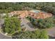 An aerial view displays a spacious clubhouse with ample parking and lush greenery in a tranquil community at 150 Center Oak Cir, Spring Hill, FL 34609